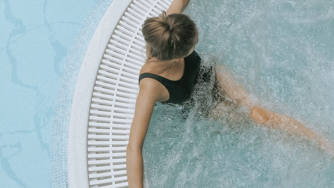 Person relaxing in a modern circular jacuzzi spa