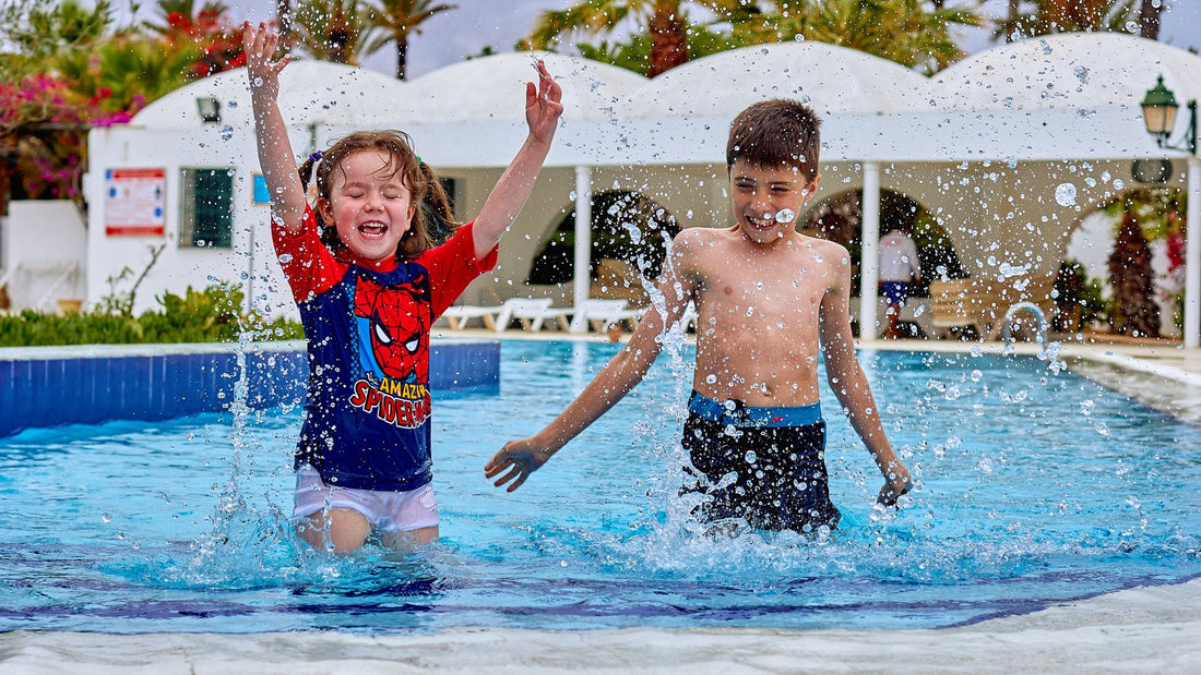 Children laughing and splashing in a home-style swimming pool