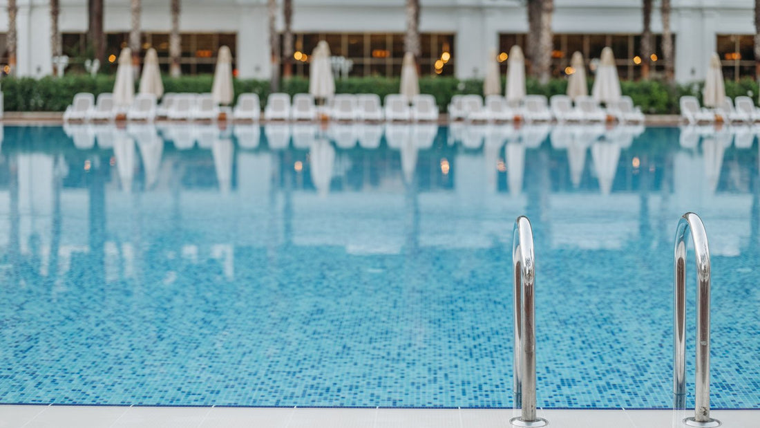 Resort swimming pool with clear blue water and pool ladder